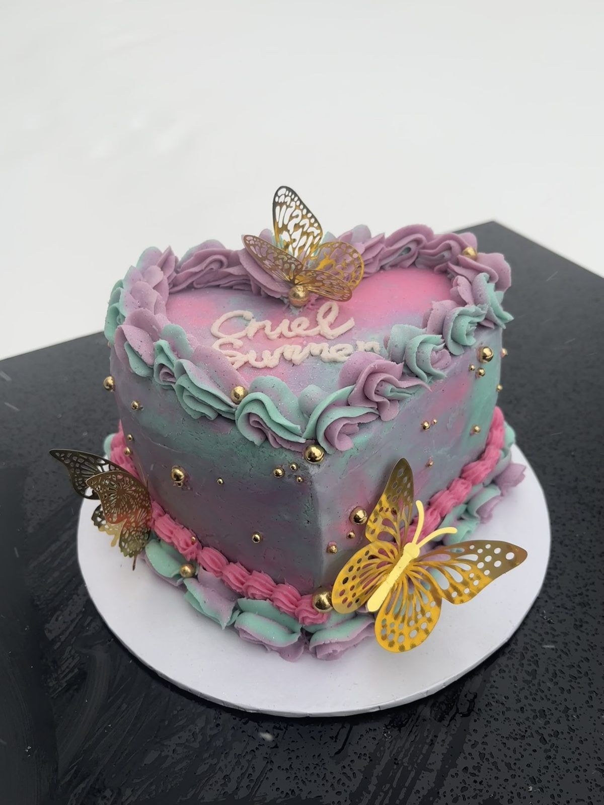 Marbled heart cake decorated with gold butterflies