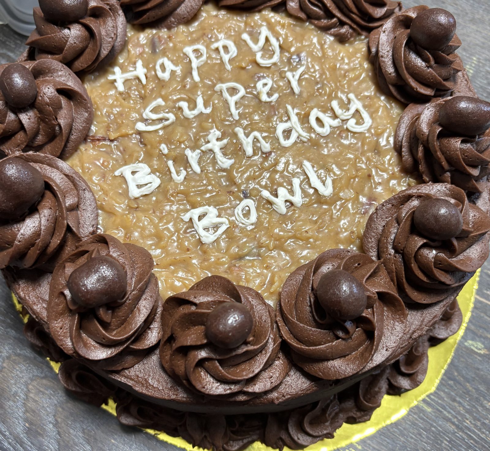 German chocolate cake with coconut pecan filling and chocolate rosettes